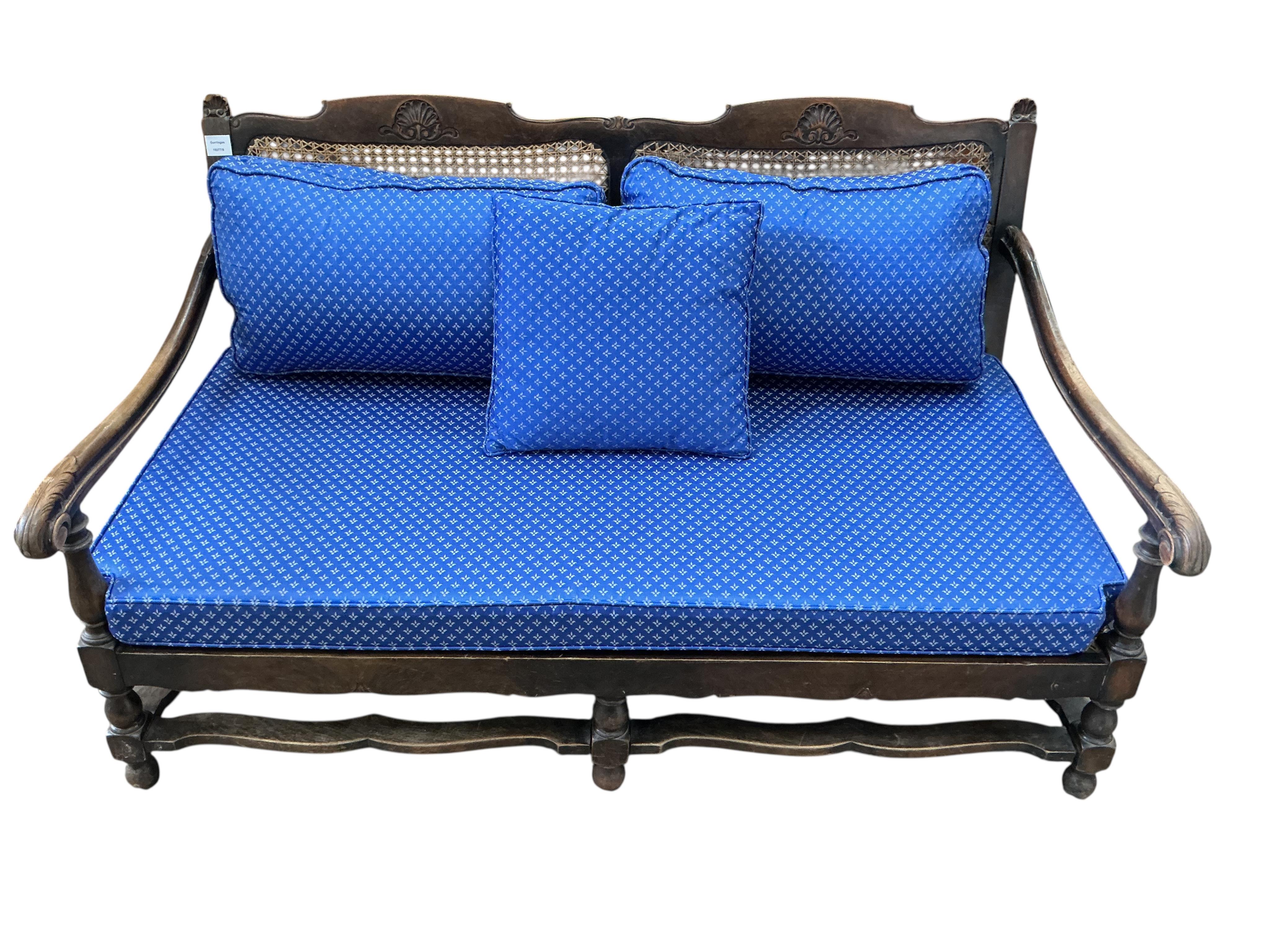 An early 20th century mahogany three piece bergere suite, settee width 174cm, height 74cm